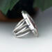 right side view, large oval wild horse magnesite gemstone silver statement ring, bezel set with stamped cutout wire accent
